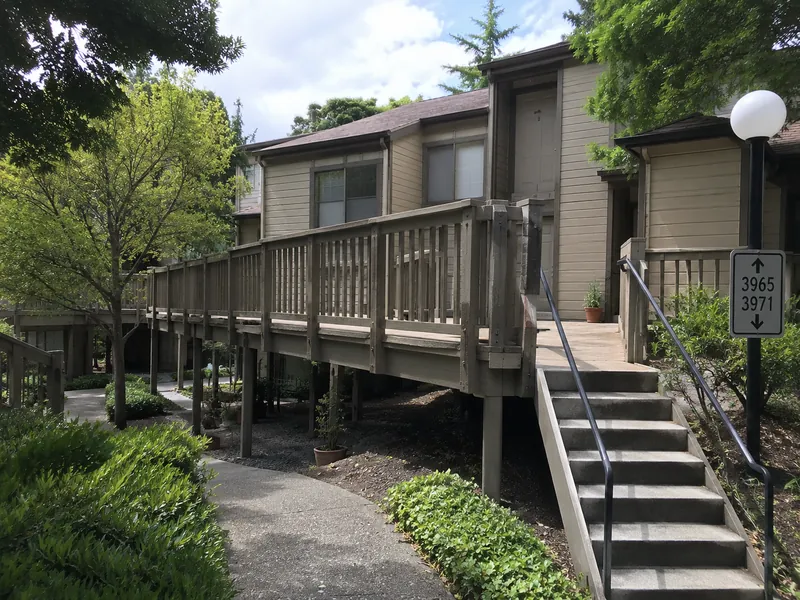 Aging elevated wood-framed walkway and stair structure at a Dublin, CA townhome HOA — subject of a litigation-support EEE assessment.