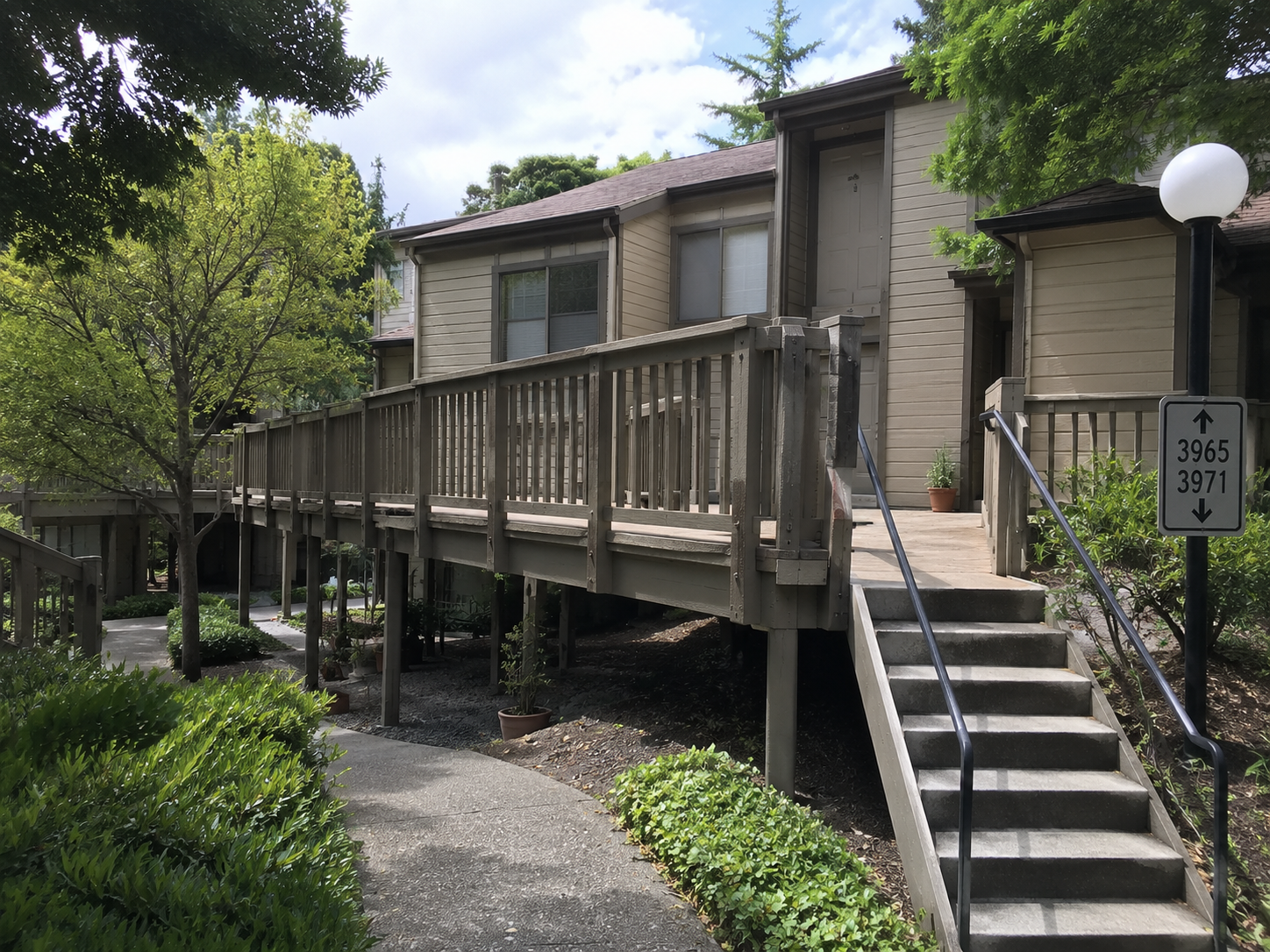 Aging elevated wood-framed walkway at a Dublin, CA townhome HOA.